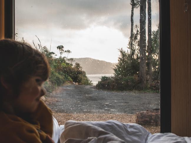 A guest snuggles up inside the cabin at Tiny Away's newest tiny home Pirates Retreat. Photo: Supplied by Tiny Away