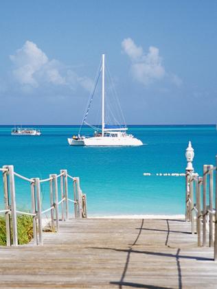 Boardwalk running towards the sea at Grace Bay beach in Providenciales, Turks and Caicos Islands in the Caribbean.