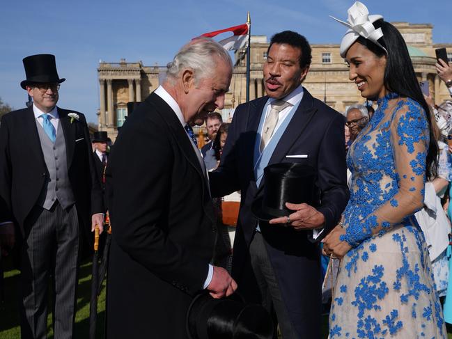 King Charles III speaks with Lionel Richie and his partner, Lisa Parigi, during a garden party at Buckingham Palace ahead of the coronation. Picture: Getty Images