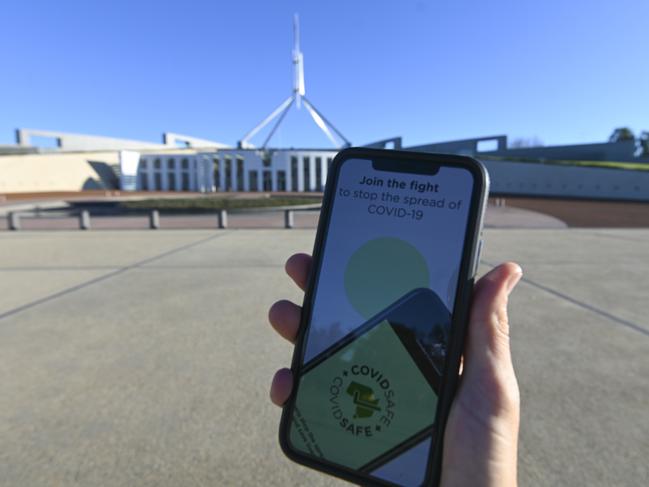 An iPhone displays the CovidSafe app in front of Parliament House in Canberra.