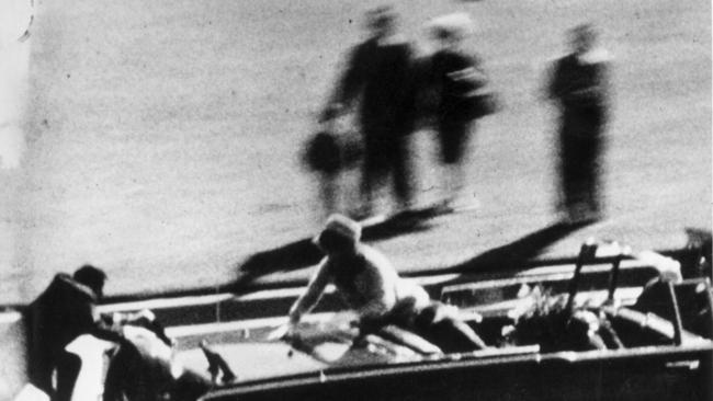 John F Kennedy moments after being shot dead during motorcade through Dallas, Texas as Jackie Kennedy is leaning over the back of the car as secret service agent tries to climb on assassination JFK.