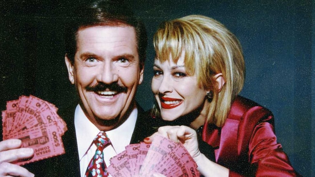 Wheel of Fortune hosts John Burgess and Adriana Xenides in 1995.