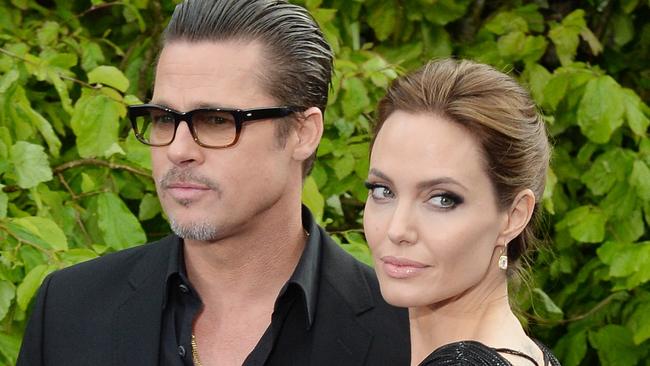 Angelina Jolie and Brad Pitt attend the screening of "Maleficent" at Kensington Palace. (Photo by rune hellestad/Corbis via Getty Images)