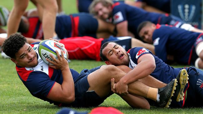 Sione Tuipulotu and Jonah Placid get physical during Melbourne Rebels training at Gosch’s Paddock. Picture: Tim Carrafa