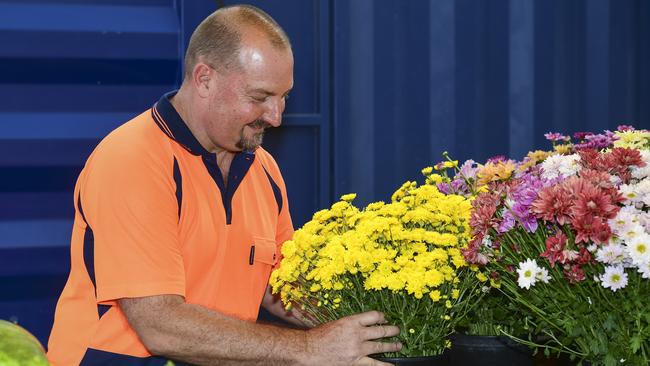 <s1>FULL BLOOM: Robert Campbell arranges the flower display at the One Little Farm pop-up shop.</s1>