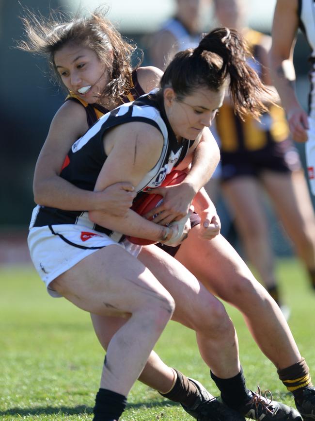 Hawthorn’s Rebecca Beeson tackles Magpie Caitlin Bunker in the VFLW.