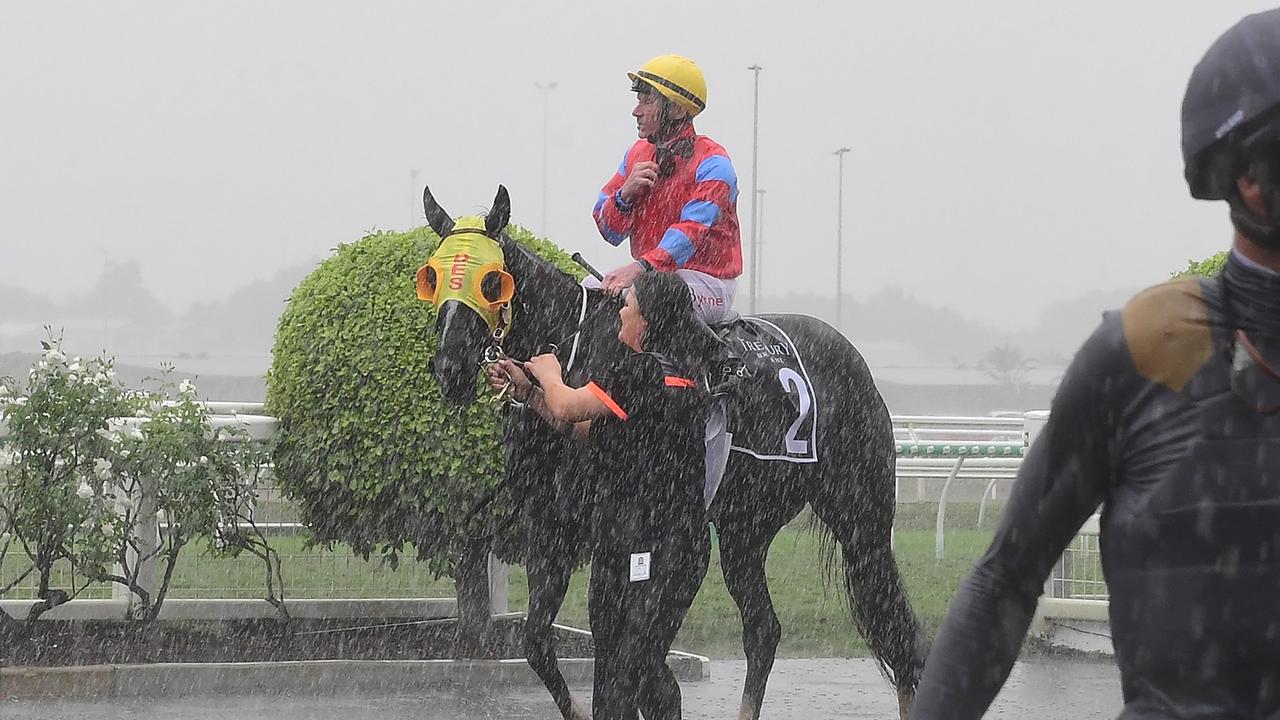 Georgie's Pride and jockey Jim Byrne return to scale as heavy rain hit Eagle Farm racecourse, May 2, 2021. Picture: Grant Peters, Trackside Photography