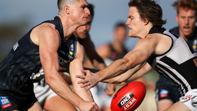 South Adelaide’s Brede Seccull handpasses past Port’s Jared Polec at Noarlunga. Picture: Matt Turner.