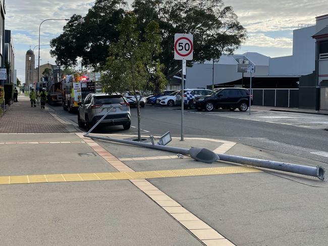 Just after 7.30am a truck uprooted a light pole from the corner of a CBD street, sustaining no damage in the process. Photo: Fergus Gregg