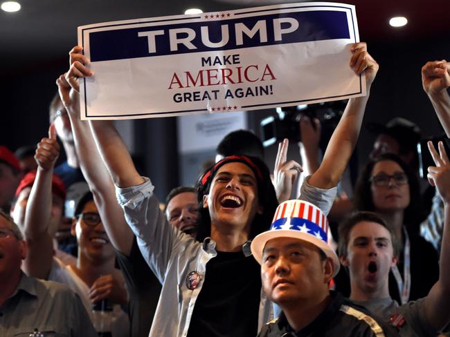 Supporters of US Republican candidate Donald Trump celebrate as they watch results at the United States Studies Center at the University of Sydney on November 9, 2016. Australia said November 9 it was crucial for Washington to stay focused on Asia if Donald Trump wins the presidential election, with Canberra keen to see more US involvement in the region, not less. / AFP PHOTO / SAEED KHAN