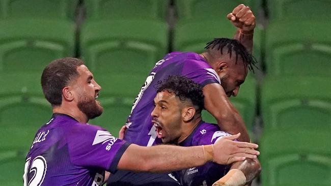 Josh Addo-Carr of the Storm celebrates after scoring a try with Justin Olam of the Storm and Kenny Bromwich of the Storm during the Round 4 NRL match between Melbourne Storm and the South Sydney Rabbitohs at AAMI Park in Melbourne, Friday, June 5, 2020. (AAP Image/Scott Barbour) NO ARCHIVING, EDITORIAL USE ONLY