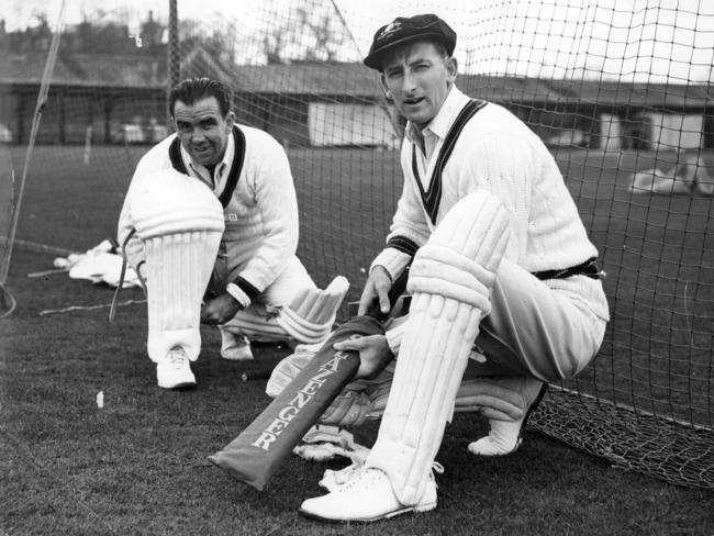 Bob Simpson and Bill Lawry pad up before a training session in the nets at Lords