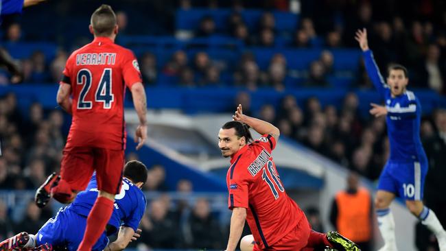 LOZlatan Ibrahimovic of PSG holds his hand up in acknowledgment.