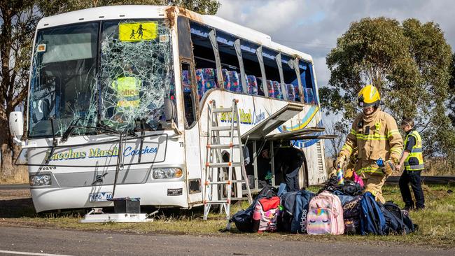 Crash scene investigators continue their investigation while emergency services pick up school bags from the scene. Picture: Jake Nowakowski