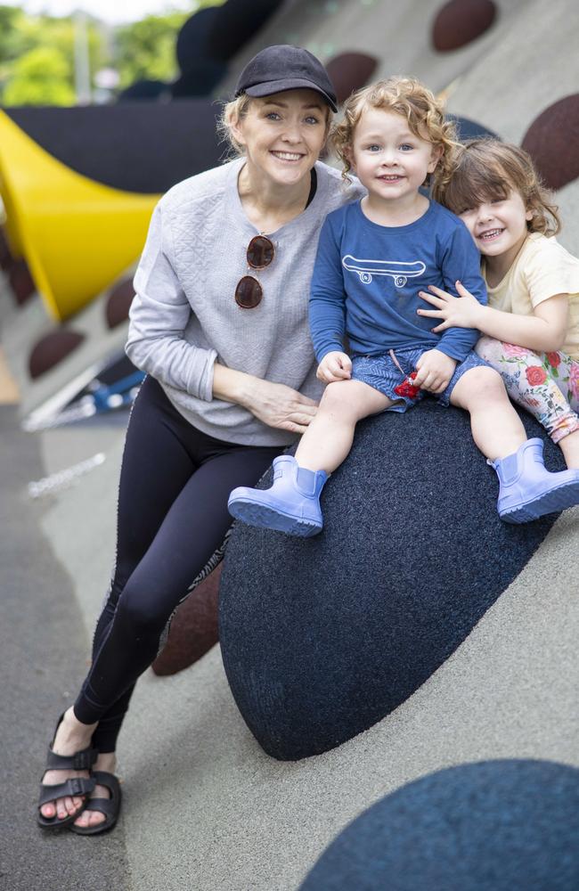 Brisbane Mum Suzy Walker with children Freddy, 2, and Isla, 3, enjoying a day at the park. Ms Walker says she doesn’t use the word COVID when she talks to them. Picture: Peter Wallis