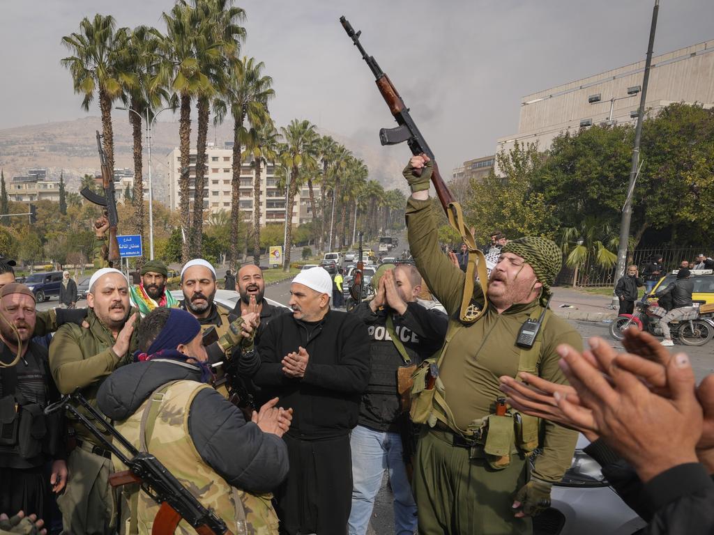 Rebel fighters celebrate the fall Damascus. Picture: AP