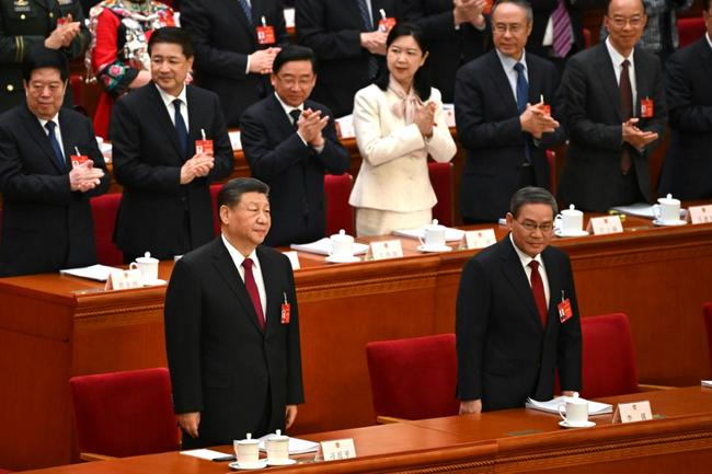 China's President Xi Jinping (front L) and Premier Li Qiang arrive for the opening session of the National People's Congress (NPC) at the Great Hall of the People in Beijing on March 5, 2024.