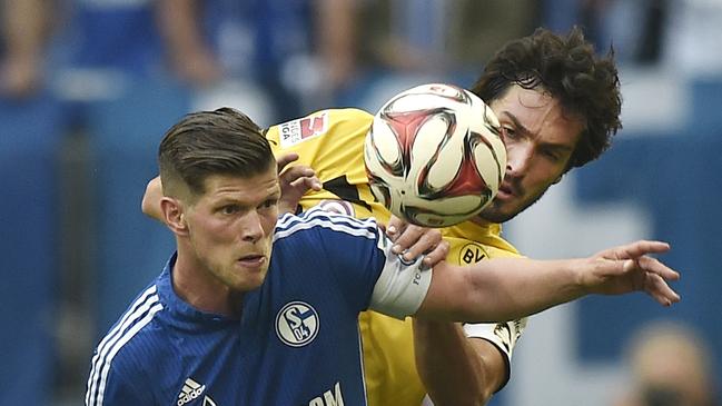 Schalke's Klaas Jan Huntelaar from the Netherlands and Dortmund's Mats Hummels, from left, challenge for the ball during the German Bundesliga soccer match between FC Schalke 04 and Borussia Dortmund in Gelsenkirchen, Germany, Saturday, Sept. 27, 2014. (AP Photo/Martin Meissner)