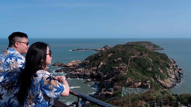 Tourists look out over an outcrop on the Matsu Islands. Hostel worker Wang Chuang-jen struggled to contact his guests arriving on the tiny Matsu archipelago in February after two undersea cables were cut, an incident that has forced Taiwan to reckon with its digital vulnerability. Picture: Jack Moore/AFP