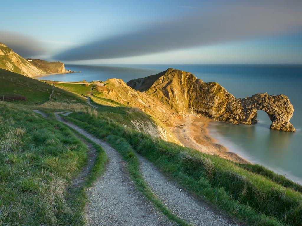 The Landscape Photographer of the Year. The last of the evening light on Durdle Door, Jurassic Coast, Dorset, England by Jake Pike (lives in Dorset) — Winner, Youth Classic view 2014 ‘Durdle Door is an iconic landmark of the South West Coast Path and of the Dorset countryside. In this image, I waited for the late evening sun to shine on the natural archway and included the coast path in my composition to add perspective to the image. The long exposure allowed me to show some movement in the clouds and to smooth out the sea.’ <a href="http://www.take-a-view.co.uk/" target="_blank">Find out more here. </a>