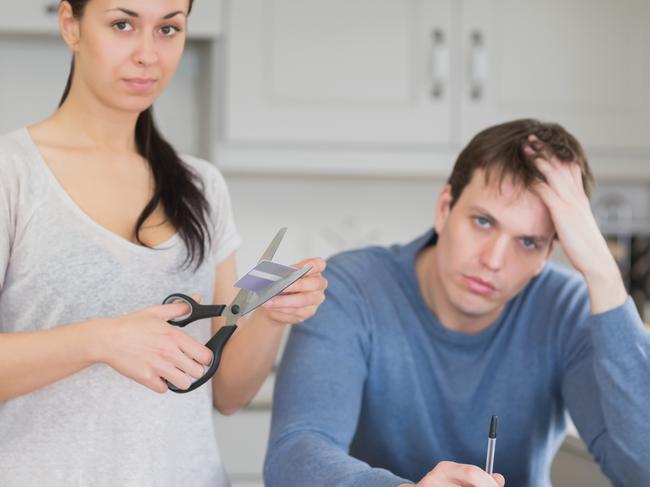 A couple stressed about money are cutting up their credit card. Picture: iStock.