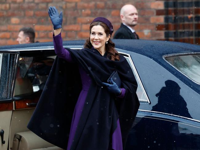 Queen Mary of Denmark waves as she arrives for the church service at Aarhus Cathedral. Picture: AFP