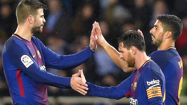 Barcelona's Luis Suarez with Lionel Messi and Gerard Pique.