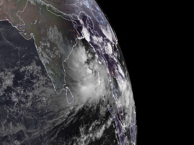 A severe cyclone is brewing off India's eastern coast, right, as the death toll rose from a major storm that wreaked havoc in the west of the virus-hit nation last week. Picture: Handout / RAMMB/CIRA / AFP