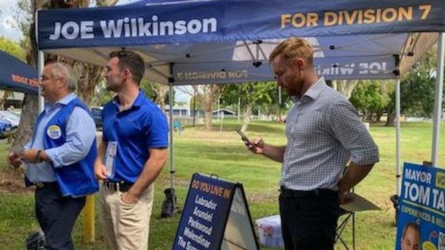 Mayor Tom Tate and suspended councillor Ryan Bayldon-Lumsden at the Runaway Bay pre-polling centre for the 2024 election. To their right, Division 7 candidate Joe Wilkinson.