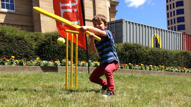 Caleb Glasson, 4, plays cricket on the Parliament House Lawns as part of the Taste of Tasmania children's events. Picture: SIMEON THOMAS-WILSON