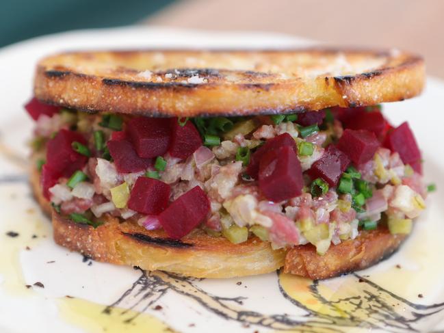 A raw beef burger with egg, pickles and beetroot on crustinis. Picture Glenn Hampson