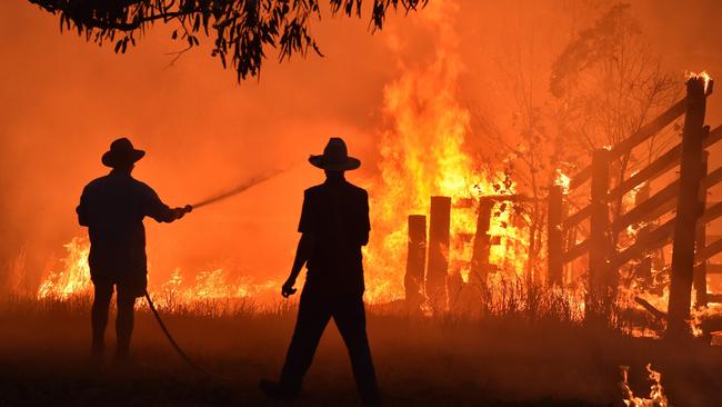 Residents defend a property from a bushfire at Hillsville near Taree. Picture: Peter Parks/AFP