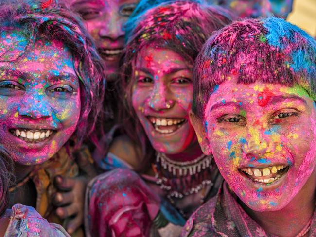 Indian children playing happy holi on sand dunes in desert village, Thar Desert, Rajasthan, India. Holi is a religious festival in India, celebrated, with the color powders, during the spring.Photo - GettyEscape 7 August 2022hot list festivals