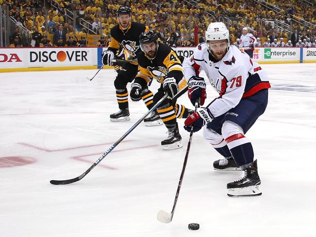 PITTSBURGH, PA - MAY 07: Nathan Walker #79 of the Washington Capitals tries to control the puck in front of Justin Schultz #4 of the Pittsburgh Penguins during the first period in Game Six of the Eastern Conference Second Round during the 2018 NHL Stanley Cup Playoffs at PPG Paints Arena on May 7, 2018 in Pittsburgh, Pennsylvania.   Gregory Shamus/Getty Images/AFP == FOR NEWSPAPERS, INTERNET, TELCOS & TELEVISION USE ONLY ==