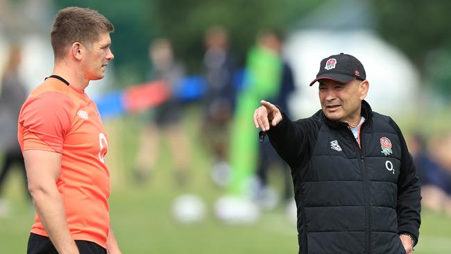 Owen Farrell of England speaks with England head coach Eddie Jones during training.