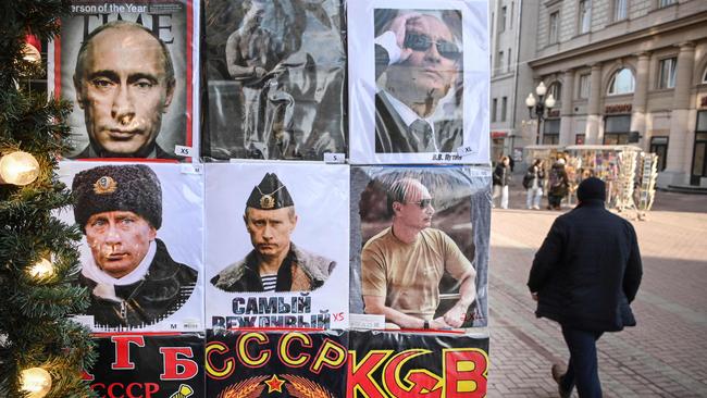 A man walks past t-shirts with images of Russian President Vladimir Putin at a gift shop in downtown Moscow this month. Picture: AFP