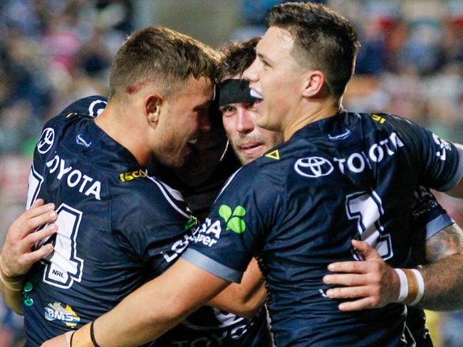 Kyle Feldt of the Cowboys (centre), is congratulated by teammates Reuben Cotter of the Cowboys (left) and Scott Drinkwater of the Cowboys (right) on his try during the Round 24 NRL match between the North Queensland Cowboys and the Canterbury Bulldogs at 1300SMILES Stadium in Townsville, Thursday, August 29, 2019. (AAP Image/Michael Chambers) NO ARCHIVING, EDITORIAL USE ONLY