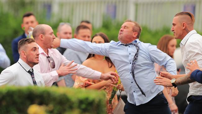 Stephen Luke (in blue shirt) punches Matthew Samuel Becker after the races. Picture: Mark Evans/Getty Images