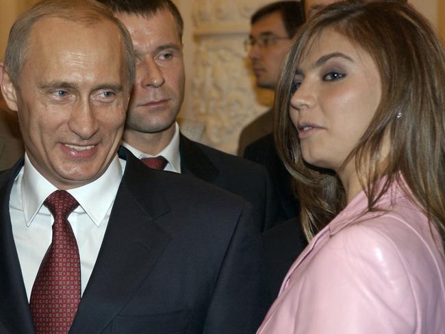 RUSSIA, MOSCOW - NOVEMBER 4, 2004:  Russian President Vladimir Putin and Olympic champion (rhythmic gymnastics) Alina Kabayeva during President's meeting with athletes-winners and Olympic champions. (Photo by TASS via Getty Images)
