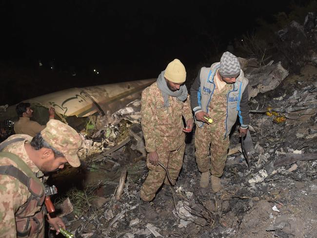 Pakistani soldiers search for victims from the wreckage of the crashed PIA passenger plane Flight PK661 at the site in the village of Saddha Batolni in the Abbottabad district of Khyber Pakhtunkhwa province on December 7, 2016. Picture: AFP PHOTO / AAMIR QURESHI