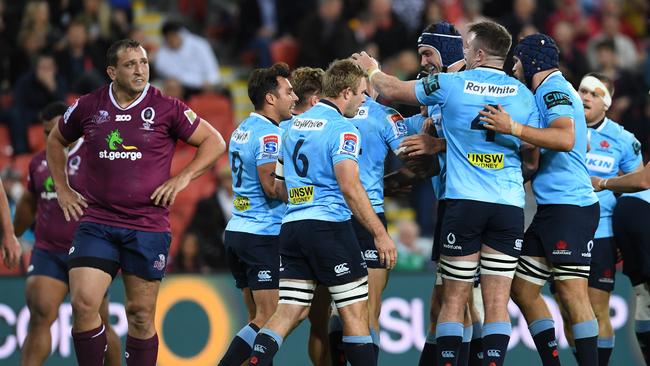 Waratahs players celebrate a try.