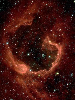 RCW 79 is seen in the southern Milky Way, 17,200 light-years from Earth in the constellation Centaurus. The bubble is 70-light years in diameter, and probably took about one million years to form from the radiation and winds of hot young stars.

The balloon of gas and dust is an example of stimulated star formation. Such stars are born when the hot bubble expands into the interstellar gas and dust around it. RCW 79 has spawned at least two groups of new stars along the edge of the large bubble. Some are visible inside the small bubble in the lower left corner. Another group of baby stars appears near the opening at the top. NASA's Spitzer Space Telescope easily detects infrared light from the dust particles in RCW 79. The young stars within RCW 79 radiate ultraviolet light that excites molecules of dust within the bubble. This causes the dust grains to emit infrared light that is detected by Spitzer and seen here as the extended red features. Picture: NASA/JPL-Caltech/E. Churchwell (University of Wisconsin-Madison)
