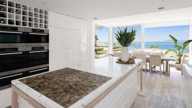 A lavish kitchen comes with sublime water views.