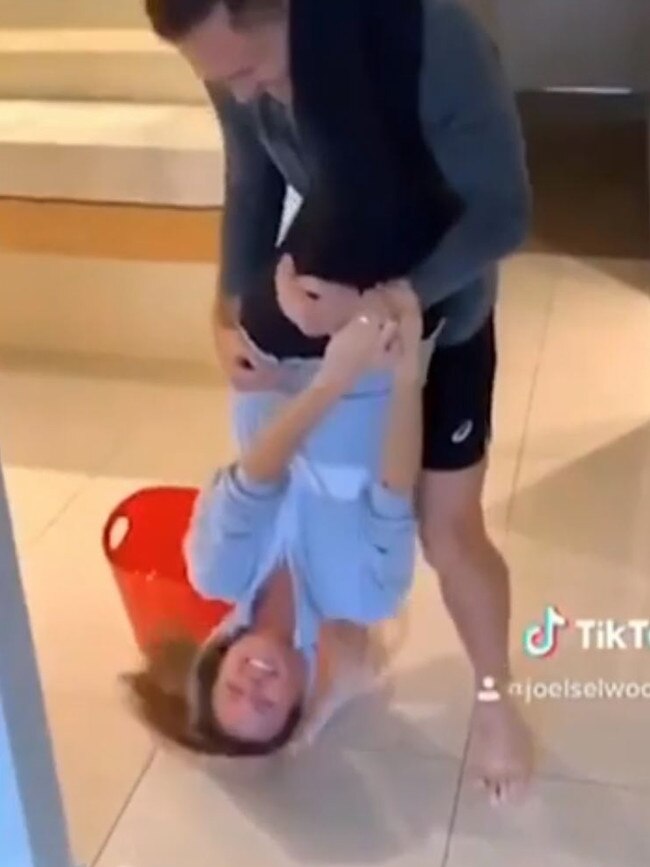 Joel Selwood using wife Brit as a mop in a TikTok clip.