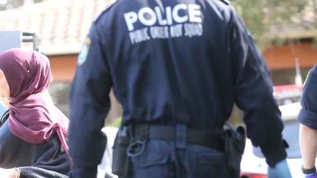 Police at a unit at Greenacre, in Sydney. Picture: John Grainger