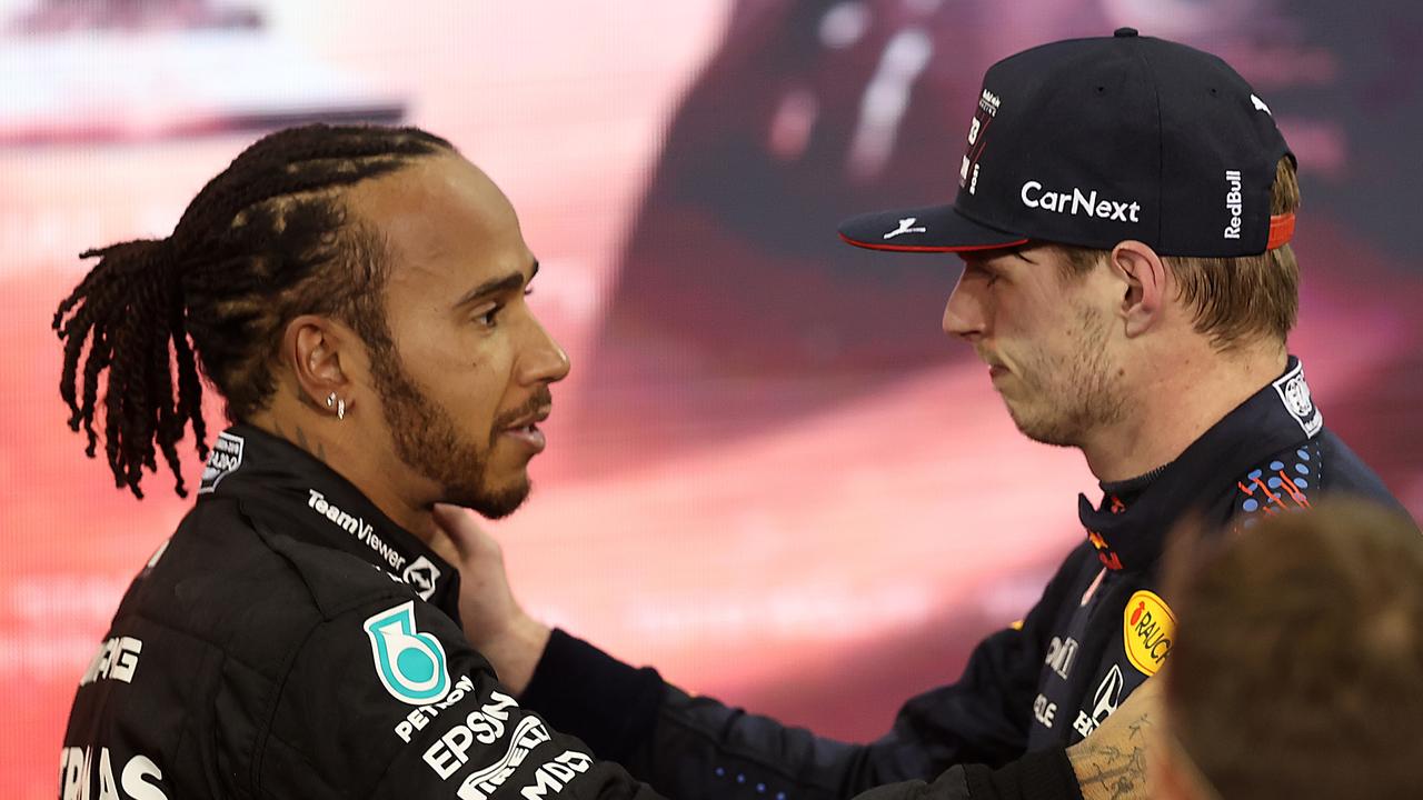 ABU DHABI, UNITED ARAB EMIRATES - DECEMBER 12: Race winner and 2021 F1 World Drivers Champion Max Verstappen of Netherlands and Red Bull Racing is congratulated by runner up in the race and championship Lewis Hamilton of Great Britain and Mercedes GP during the F1 Grand Prix of Abu Dhabi at Yas Marina Circuit on December 12, 2021 in Abu Dhabi, United Arab Emirates. (Photo by Lars Baron/Getty Images) *** BESTPIX ***