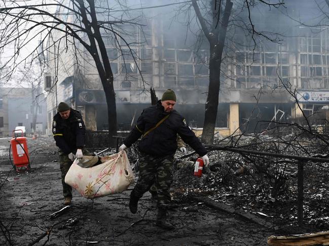 Police officers remove the body of a passer-by killed in air strikes that hit Kyiv's main television tower. Picture: AFP