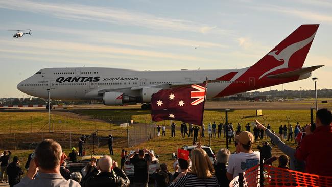 Onlookers in July farewell Qantas’s last Boeing 747 as it goes into retirement. Now Boeing says it will phase out production of the iconic jet. Picture: AFP