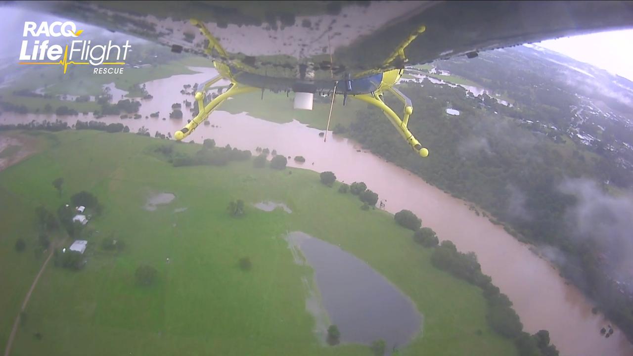 The Sunshine Coast RACQ LifeFlight Rescue crew flies over the Gympie region on its way to rescue a family of five and their dog from Amamoor Creek.