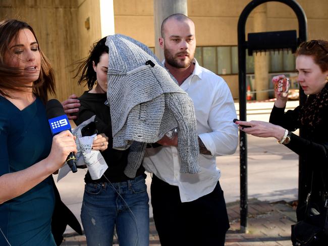 Sarah Budge, girlfriend of Kings Cross identity John Ibrahim, tries to evade reporters with her brother Jack after being released on bail. Picture: AAP/Dan Himbrechts